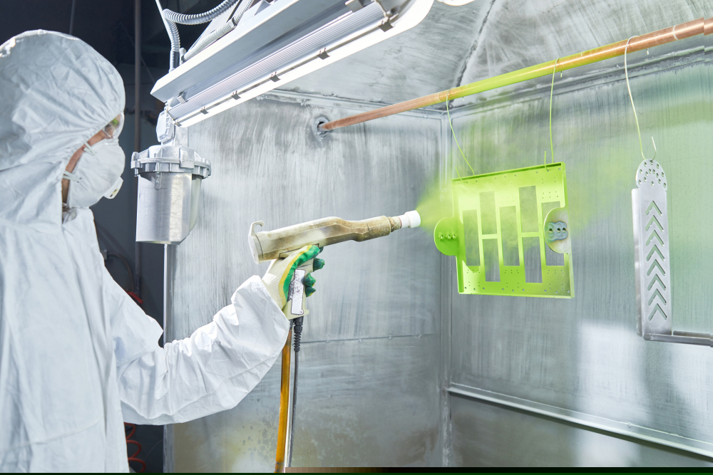 Powder,Coating,Of,Metal,Parts.,Worker,Wearing,Protective,Wear,Performing Person spray coating aluminium on a rack