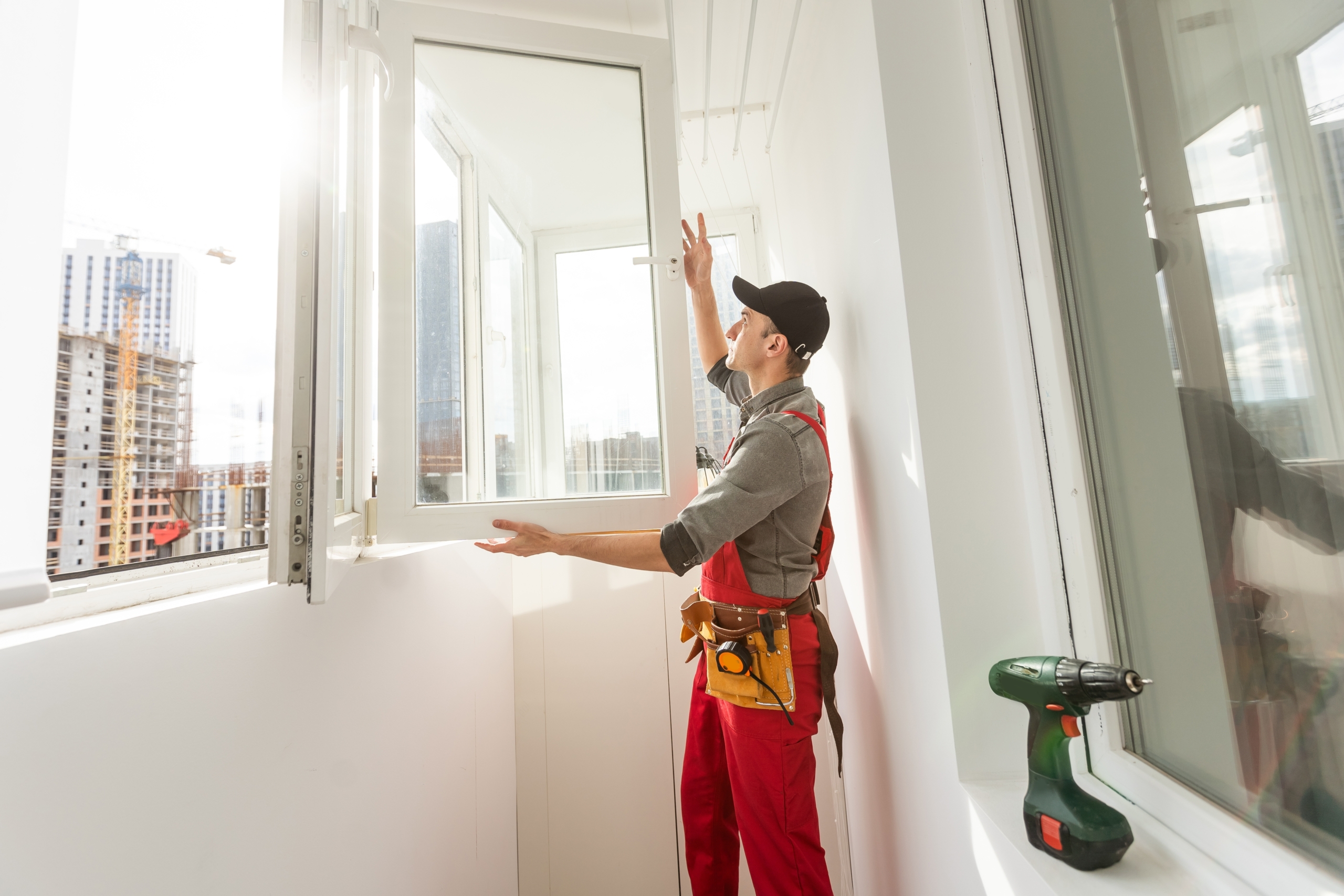 Worker,Sealing,Plastic,Window,With,Caulk,Indoors.,Installation,Process